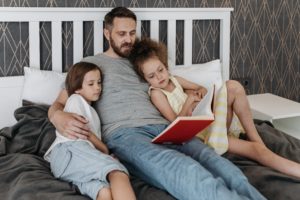 Father reading to his daughters - Family Lawyers New Jersey 