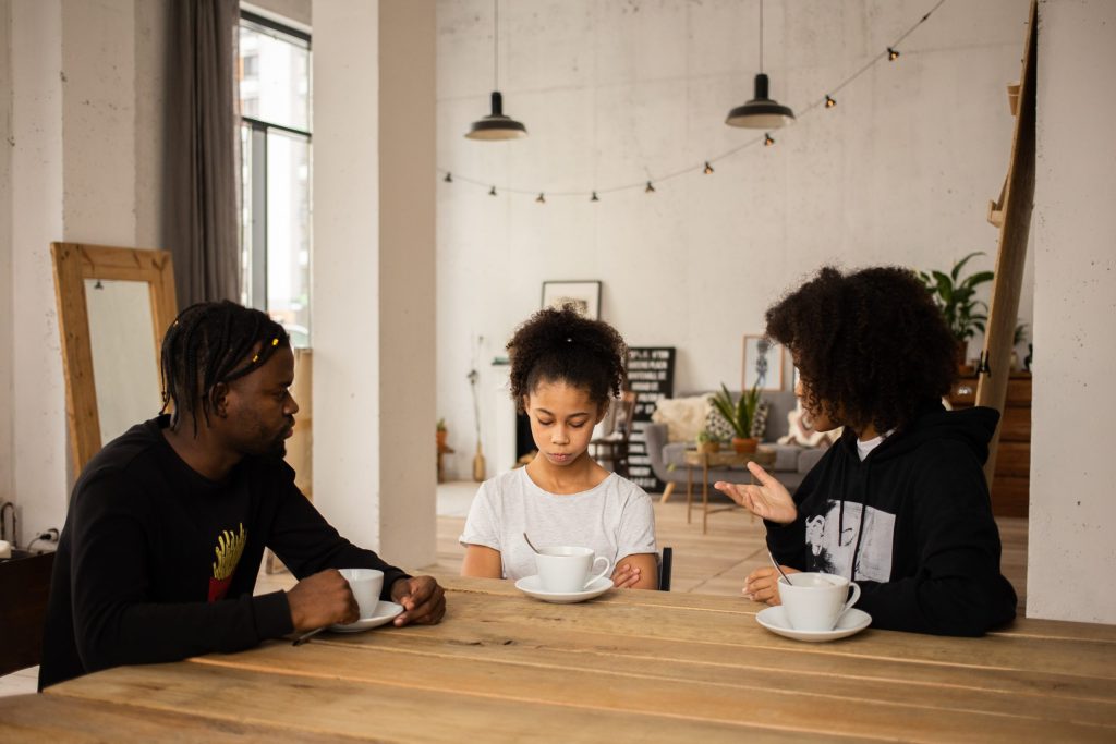 two parents talking with their young child