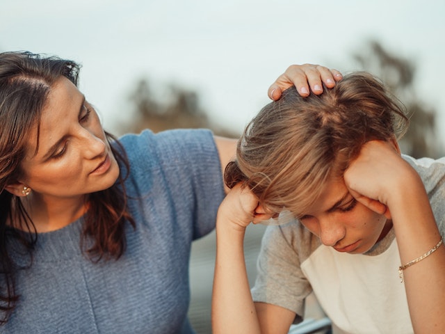 mother consoling sad child