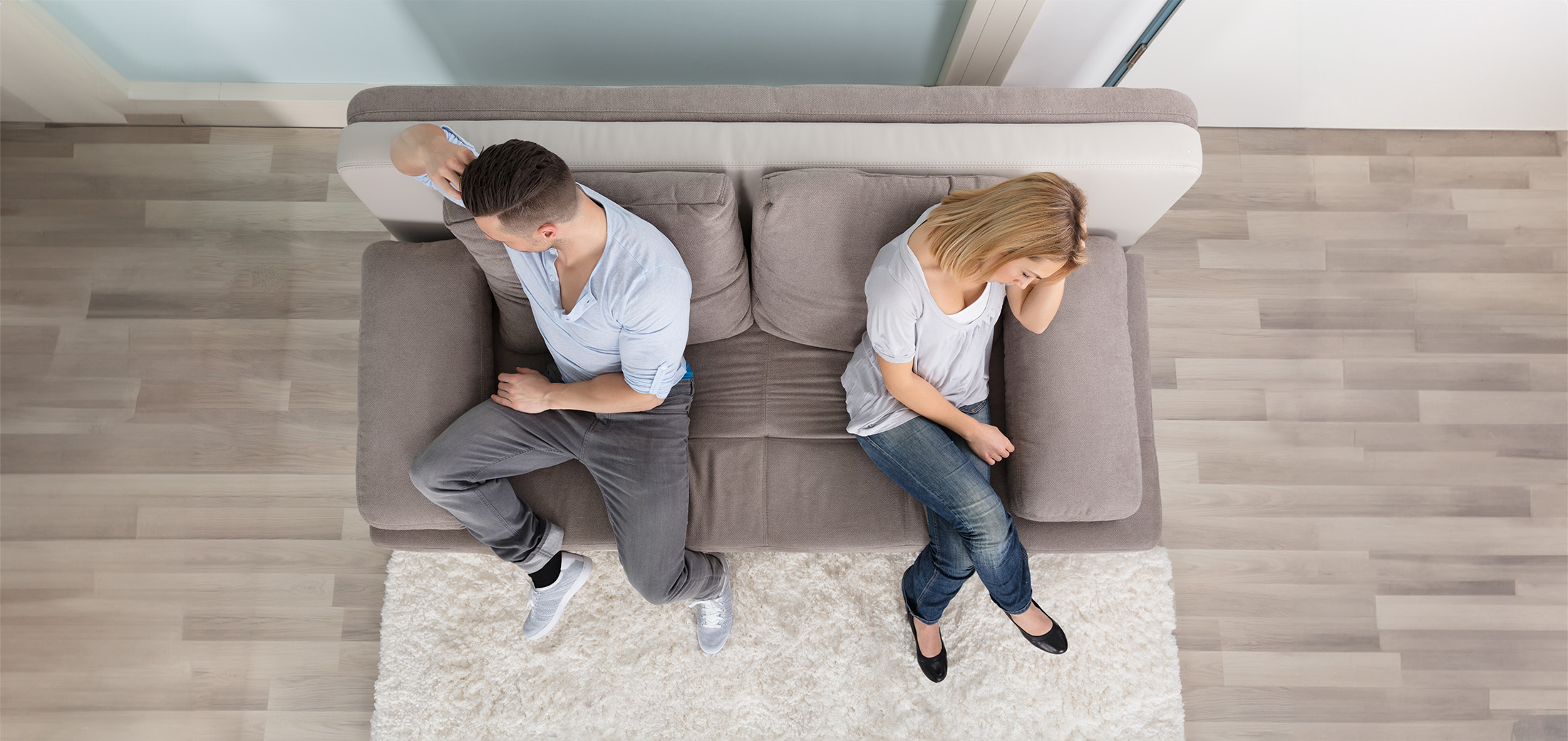 upset couple sitting on couch