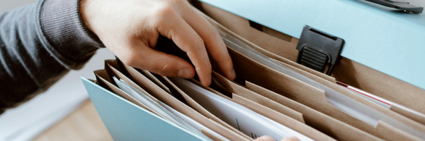 hands going through a file cabinet stack