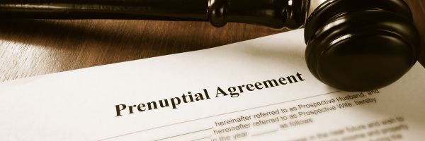 A document titled "Prenuptial Agreement" on a desk, highlighting the importance of prenups in marriage, with a wooden judge's gavel resting nearby. From Lawrence Law Firm New Jersey Family Lawyer.