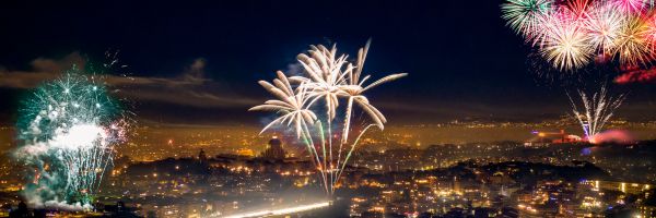 Fireworks light up the night sky over a cityscape, with buildings illuminated below and bursts of color visible above—marking new beginnings, much like when you file for divorce in NJ to start a fresh chapter. From Lawrence Law Firm New Jersey Family Lawyer.